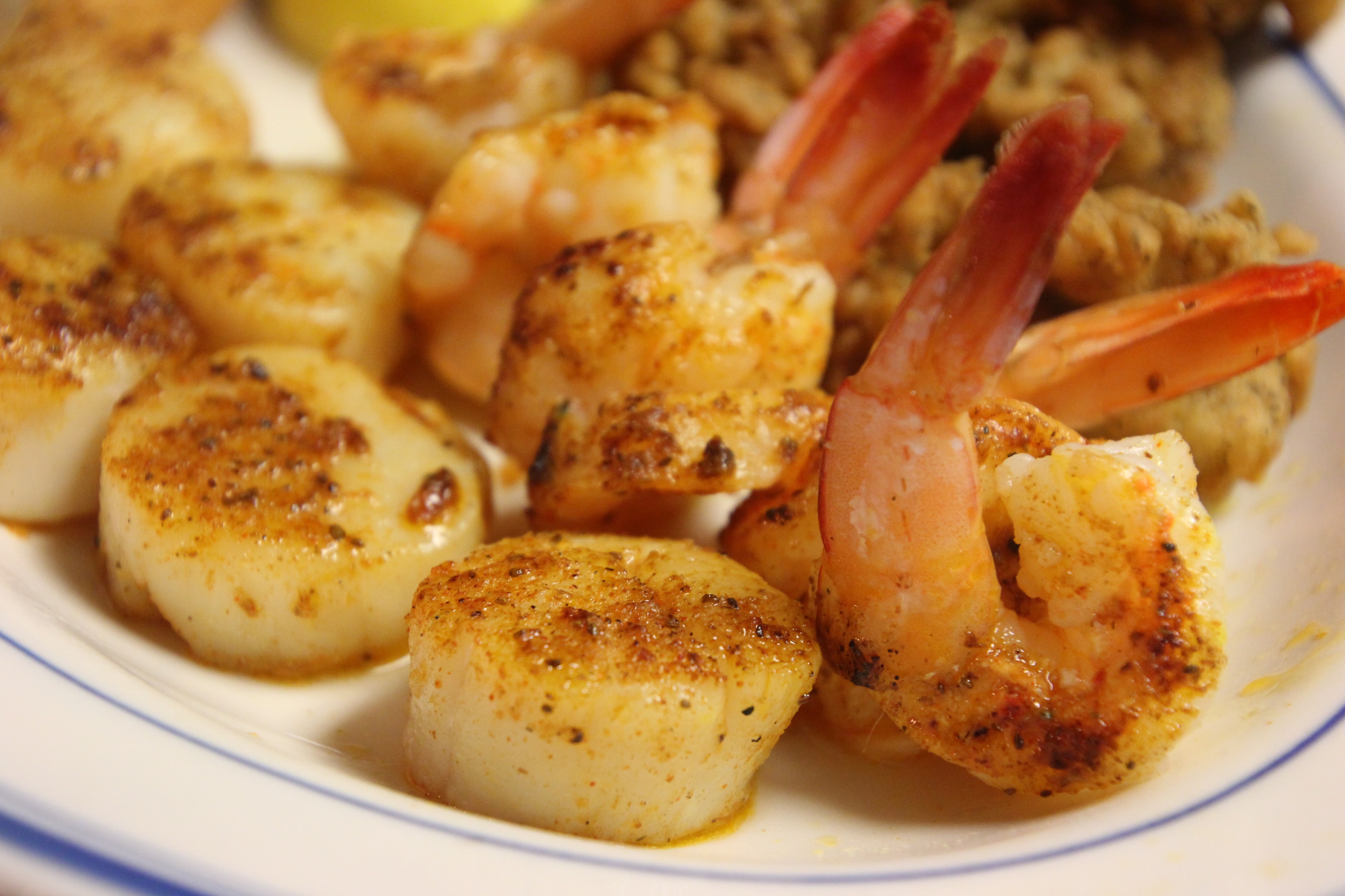 Broiled scallops and shrimp seasoned with Cajun spices served with dirty rice